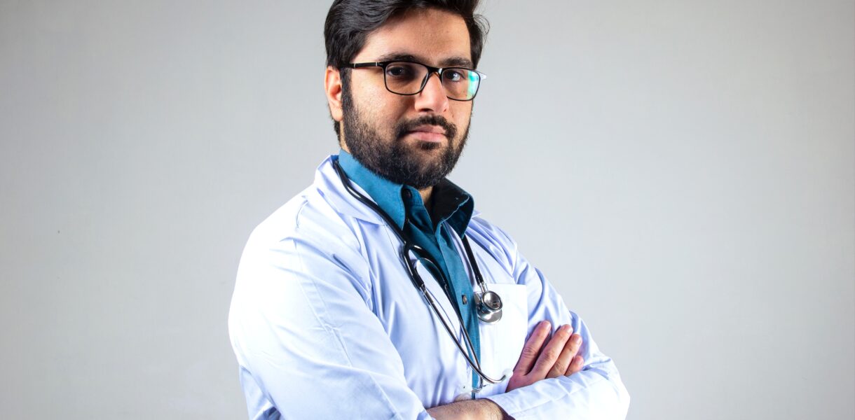 Male Indian medical doctor poses with folded hands