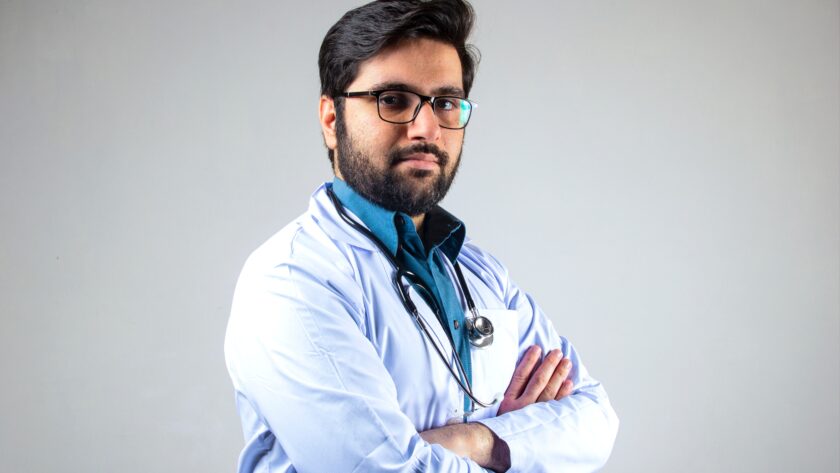 Male Indian medical doctor poses with folded hands